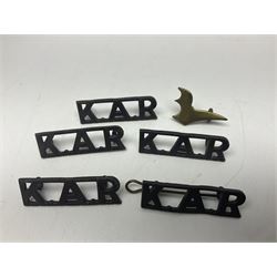 Over thirty British and Continental military metal badges; together with quantity of shoulder titles, collar dogs, rank pips, uniform buttons etc