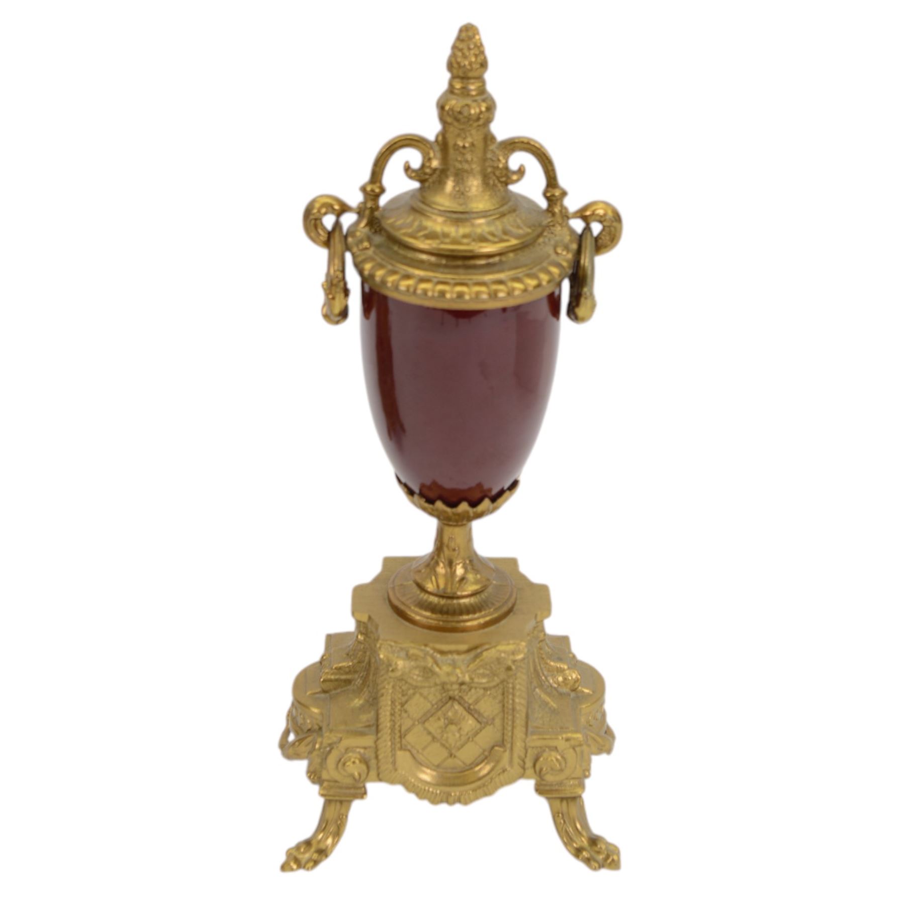 Continental-20th century clock garni in a mid 19th century style case, with porcelain panels and dial, spring driven two train movement with a floating balance escapement, striking the hours and half hours on two bells. With conforming urns. 