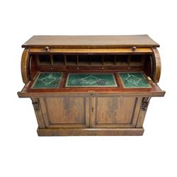 Victorian mahogany roll-top writing desk, top concealing fitted interior with pigeonholes and three drawers, the trisector inset writing surface with writing slope, base fitted with panelled cupboard enclosing single shelf, decorated with scrolled corbels