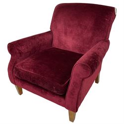 Duresta - traditional shape armchair upholstered in burgundy red velvet, on square tapering front supports (W88cm, H85cm, D103cm); together with a matching rectangular footstool with hinged seat, on turned feet with brass castors (73cm x 54cm, H38cm)