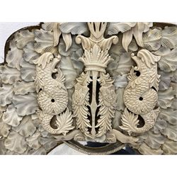 Pair 19th century French Dieppe bone and ivory wall mirrors, the oval bevelled mirror plates within rectangular frames with shaped tops, profusely decorated with ivory leaves, further detailed with carved bone armorial type crest inscribed 'SGOTORVM', putti, fish and mask heads, H81cm W48cm