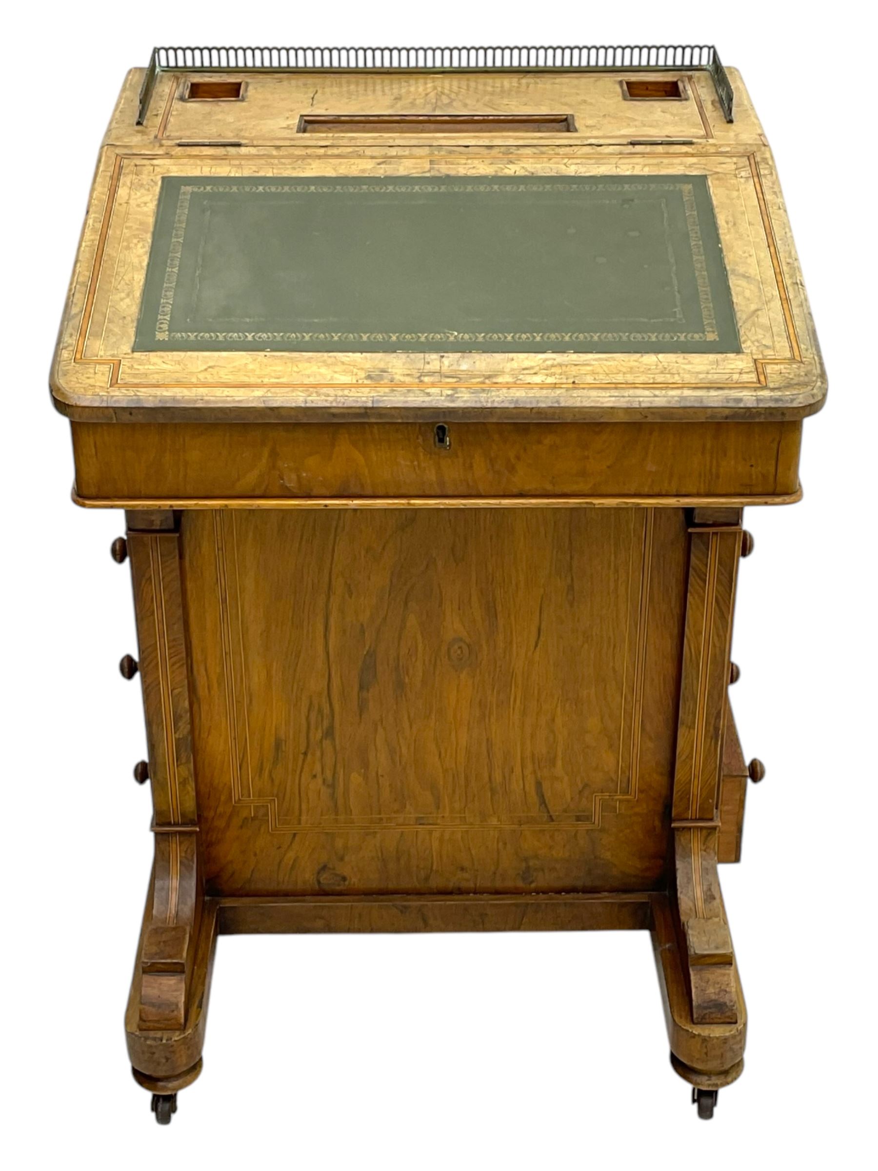Early 19th century burr walnut Davenport desk, sloped leather-inset writing surface with brass gallery, fitted with an inkwell compartment and pen slot, four drawers to one side, raised on scrolled supports terminating in castors