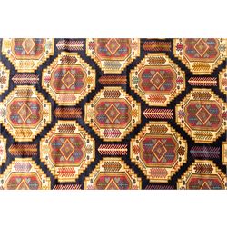 Central Asian Turkmen, main field with octagonal guls enclosing hooked diamond motifs in shades of madder gold, ivory, and indigo set against a dark ground within multiple polychrome borders of geometric devices and stepped motifs 