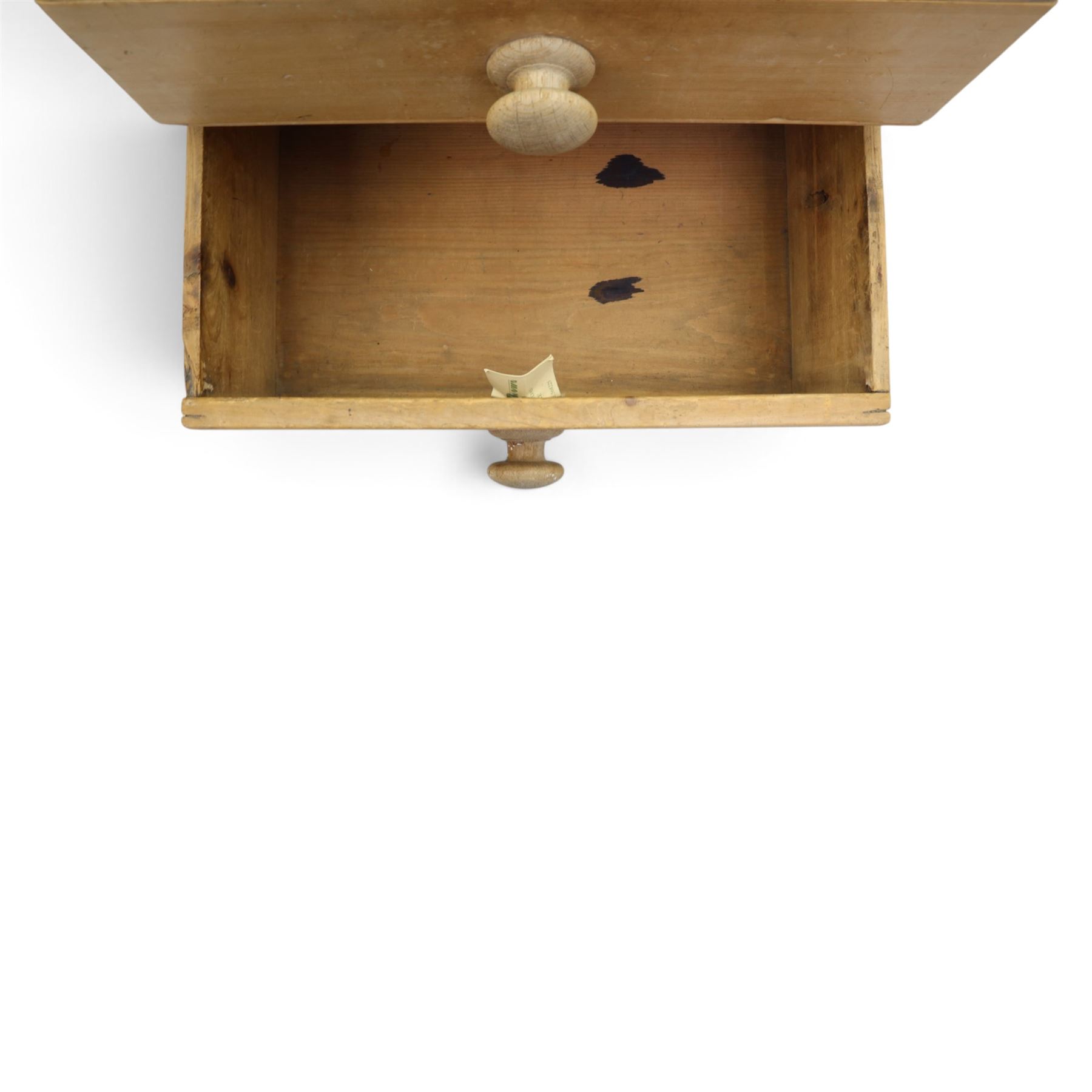 Victorian stripped pine sideboard, rectangular plank top rounded edges, with central cupboard door with shaped panel, flanked by two banks of three graduating drawers with turned knobs, raised on a plinth base 