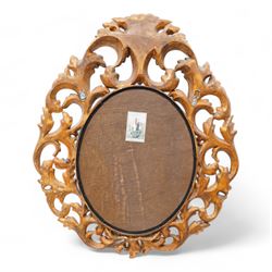 Florentine design gilt wall mirror, bevelled oval mirror plate surrounded by scrolling and interlaced acanthus leaves, curled leaf pediment 