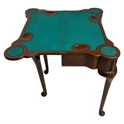 Victorian mahogany card table, the shaped fold-over top reveals baize playing surface and sunken counter wells, the shaped frieze rail mounted by carved leaf motif, double gate-leg base, on cabriole supports 
