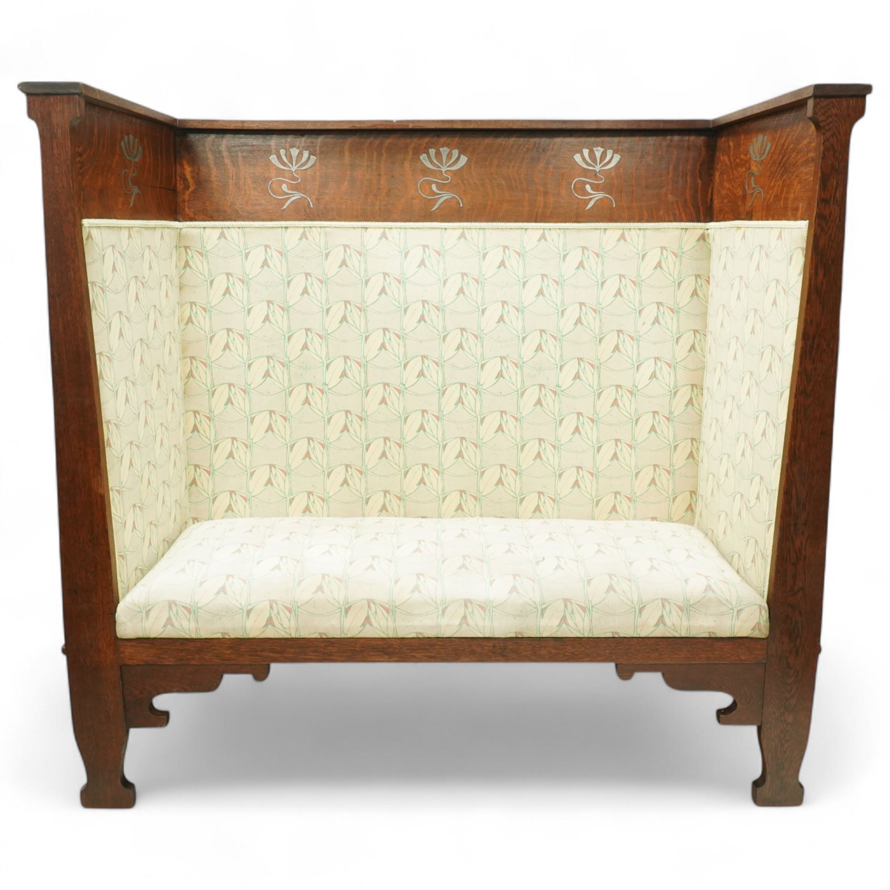 James Shoolbred & Co. (1814-1934) - Arts & Crafts high-back oak settle or hall-bench, the projecting cresting rail over a frieze decorated with stylised poppy pewter inlays, the drop-in sprung seat beneath high back and arms, flanked by tapering uprights terminating to shaped stile feet, upholstered in Archibald Knox patterned fabric with the original tapestry and horsehair upholstery beneath, applied plaque by James Shoolbred to underside, with stamped serial number W1573, circa 1890