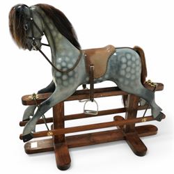 Wooden rocking horse, in Dapple Grey paint finish with reins and stirrups, on pine trestle base, metal plaque inscribed 'Hoppringle Horses by J. J.V. Eyre Hoppringle by Stow, Galashiels TD1 2TJ'