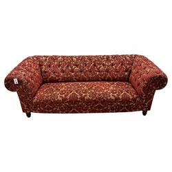 Late 20th century upholstered Chesterfield sofa, in red damask floral fabric, with deep buttoned back and arms, scrolled arms at equal height to back, on turned front supports