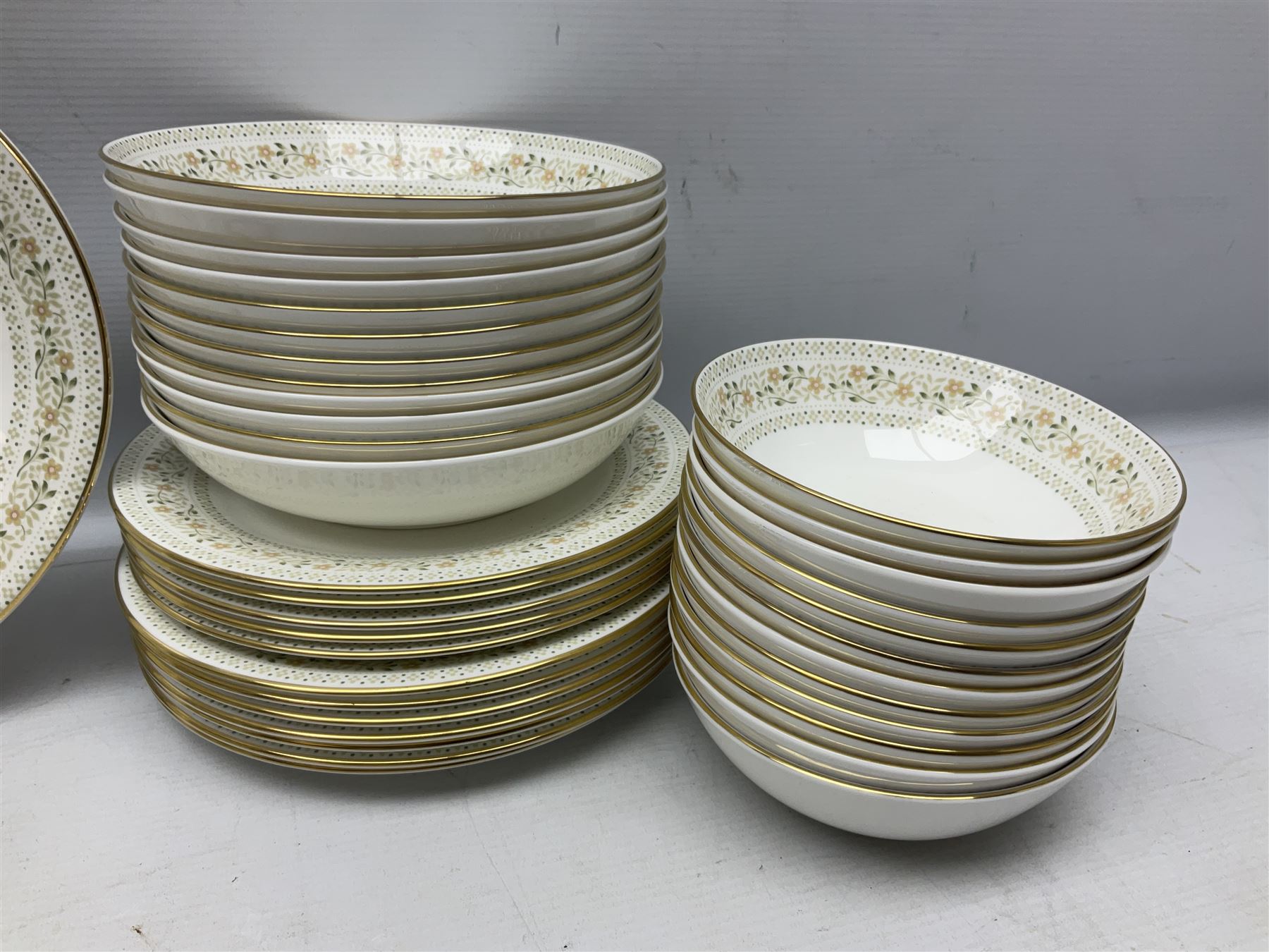 Royal Doulton Paisley pattern tea and dinner service for twelve, comprising dinner plates, side plates, soup bowls, dessert bowls, tea plates, two lidded tureens, sauce boat and saucer, sucrier and jug, oval serving dish and teacups and saucers