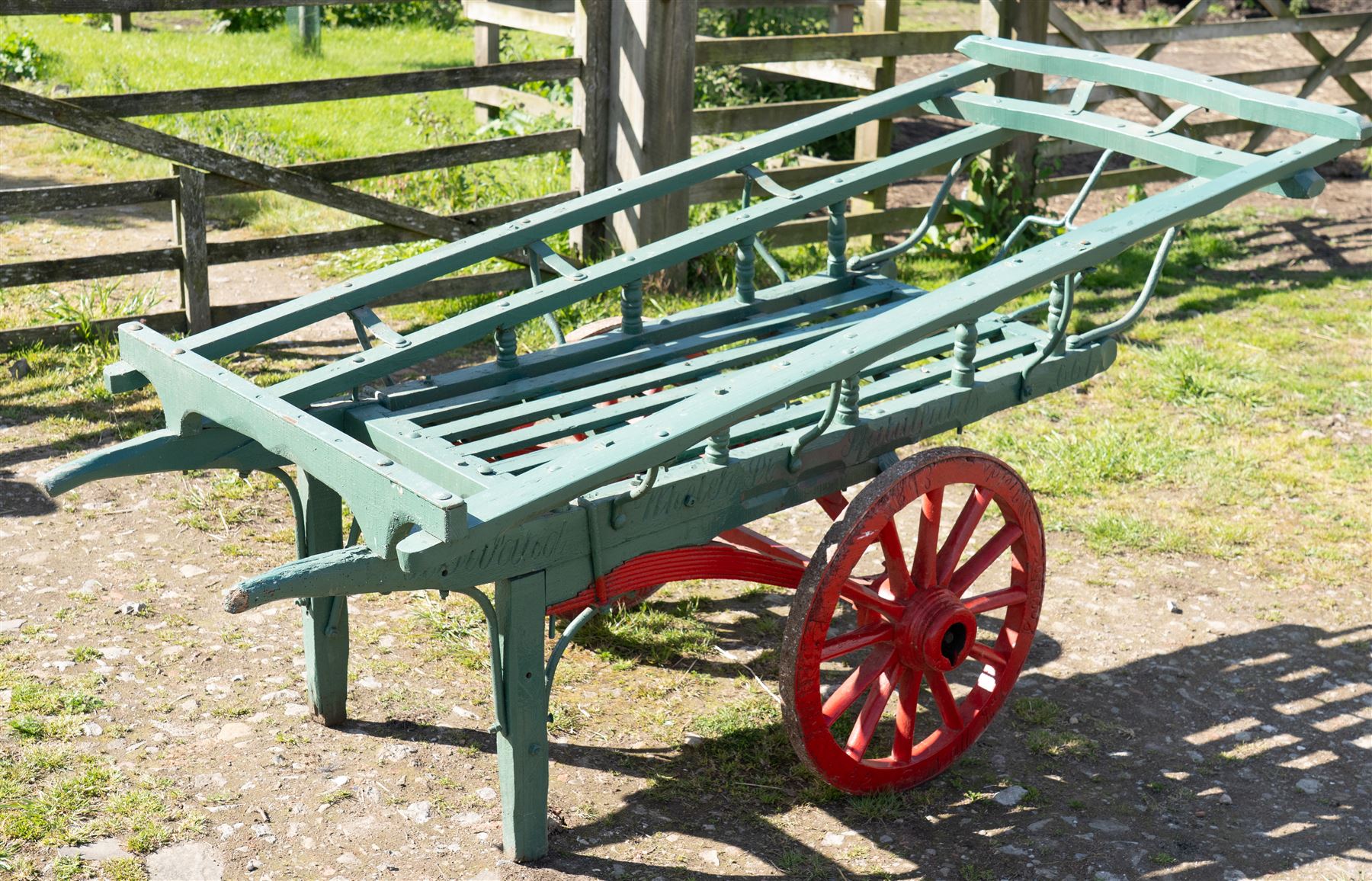 Costermonger’s Cart

A painted costermonger’s cart with green slatted timber body, red painted wooden spoked wheels and red leaf spring suspension. The cart is fitted with raised side rails, turned supports and short projecting handles. Painted lettering is visible along the side rails, together with the number “661” to the frame and wheel rim.
Finished in traditional colours, the cart offers excellent decorative appeal and would be suitable for display, garden or country house settings.

Dimensions:
Overall length: 240 cm
Body length: 215 cm
Width: 94 cm
Height: 86 cm
Wheel diameter: 64 cm

Features:
Timber construction
Open slatted carrying platform
Shaped side rails
Leaf spring suspension
Wooden spoked wheels
Iron tyres
Iron fittings throughout
Carved ownership and maker inscriptions
Traditional painted finish

