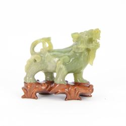 Chinese green carved temple lion upon hardwood stand, H13cm
