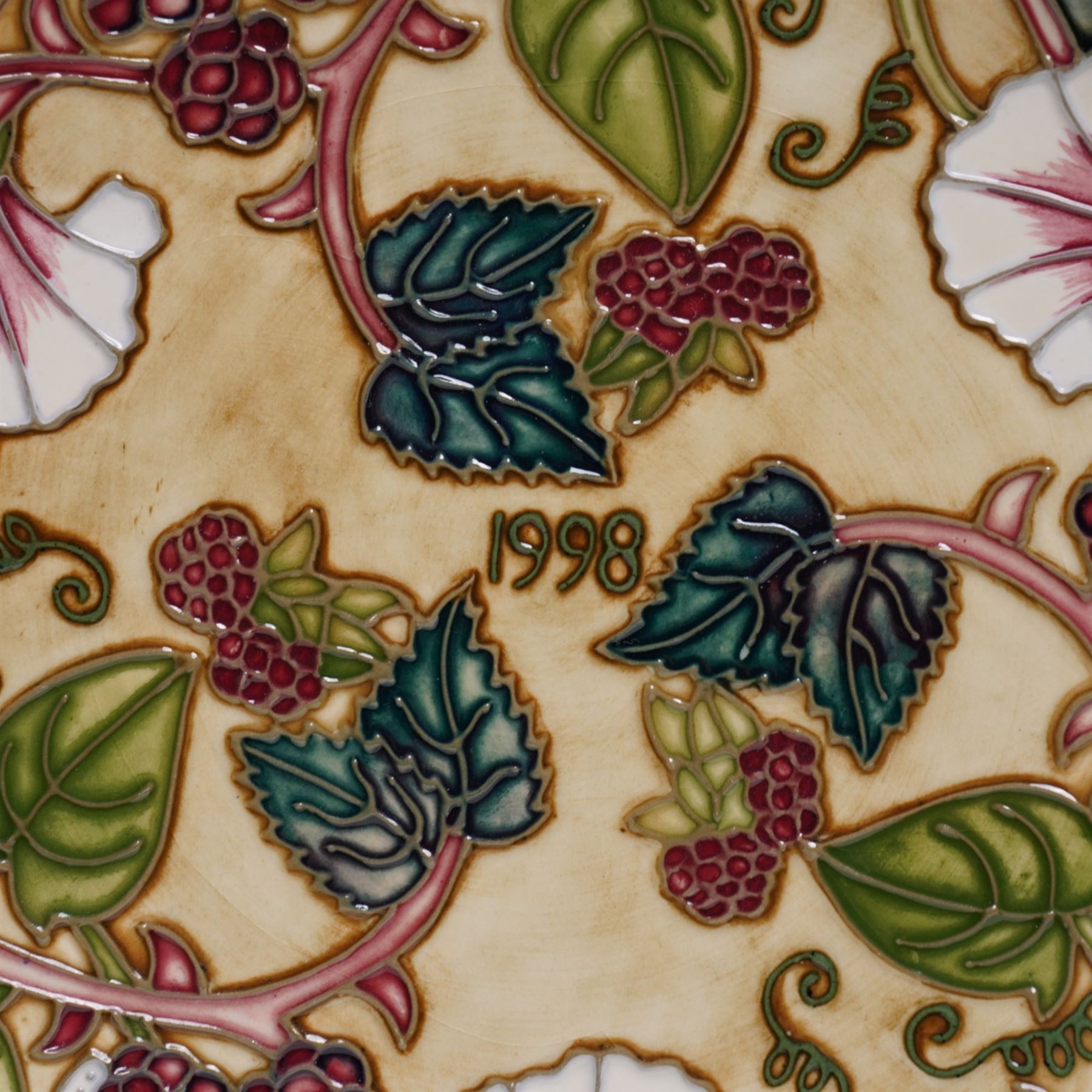 Moorcroft limited edition Birth of Light pattern millennium year plate, numbered 699/2000, impressed and painted marks to base; together with three other year plates comprising 1998, 1992 and Spitalfields Temple Mills edition 1991 plate (4)