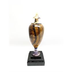 Early 19th century and later Blue John urn, Winnats one vein, of ovoid form with integrated cover and ball finial, upon a spreading circular base, and square stepped black lacquered base, H34.5cm