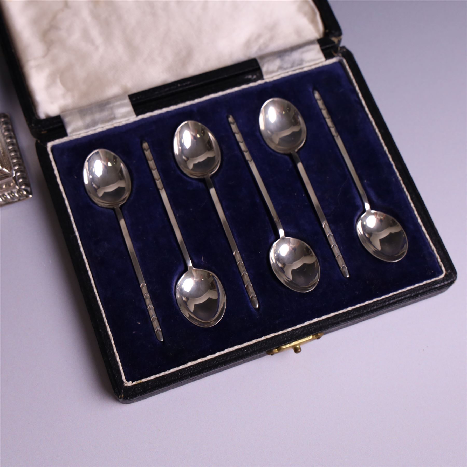 Late Victorian silver mounted stamp box, the hinged lid with three glazed panels, hallmarked Grey & Co, London 1900, together with a late Victorian silver hair comb and a cased set of six silver coffee spoons
