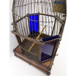 George III bird cage, the mahogany and rosewood base with geometric inlay, brass ball feet, conforming brass ball knops and ivory handles to the sliding floor, supporting a domed wirework cage with two frosted and two blue glass panels, and turned acorn finial, H54cm 
