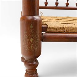 Pair of Anglo-Indian brass inlaid hardwood low chairs, the backs with turned spindle rails and rectangular panels inlaid with scrolling foliate decoration, woven rush seats within moulded frames, raised on turned supports with ring turned feet