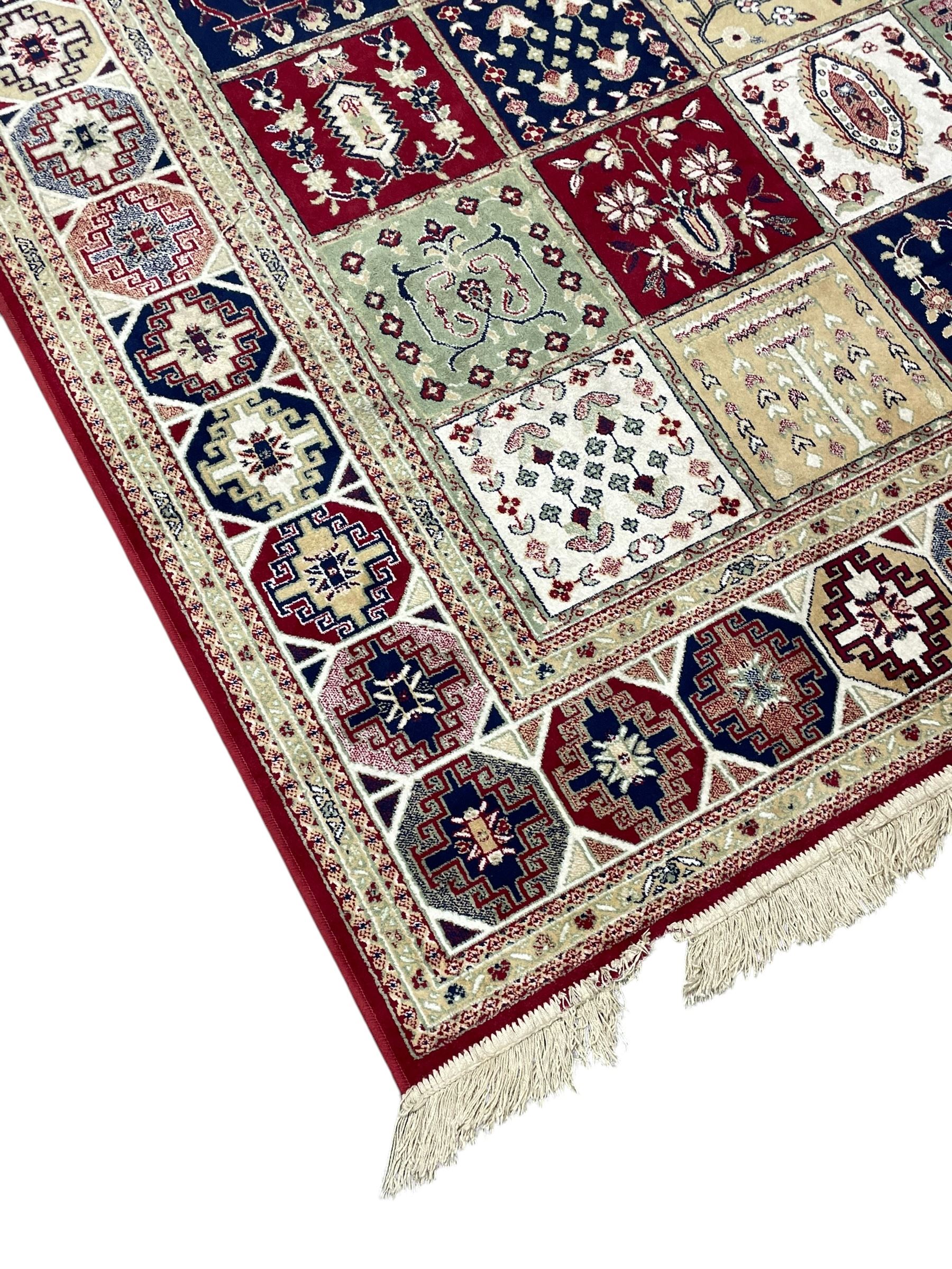 Bakhtiari design rug, the field divided into panels each decorated with tree of life and floral motifs, the main border decorated with Hac motifs 
