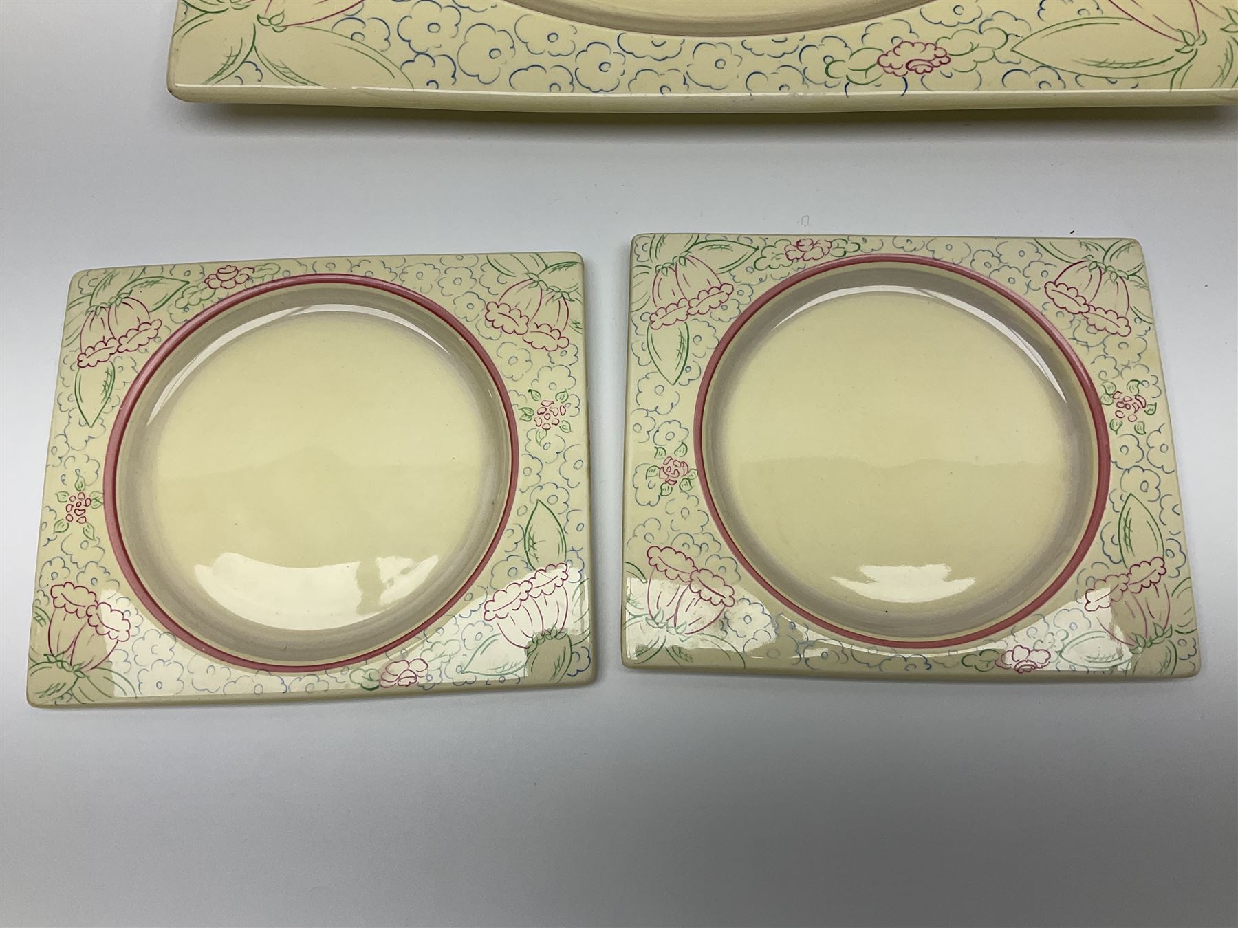 Clarice Cliff Biarritz part dinner set, circa 1930, for Royal Staffordshire, of rectangular form, decorated with bluebells, to include one serving plate, six dinner plates, three side plates, etc, printed mark beneath with reg no 784849 (17)