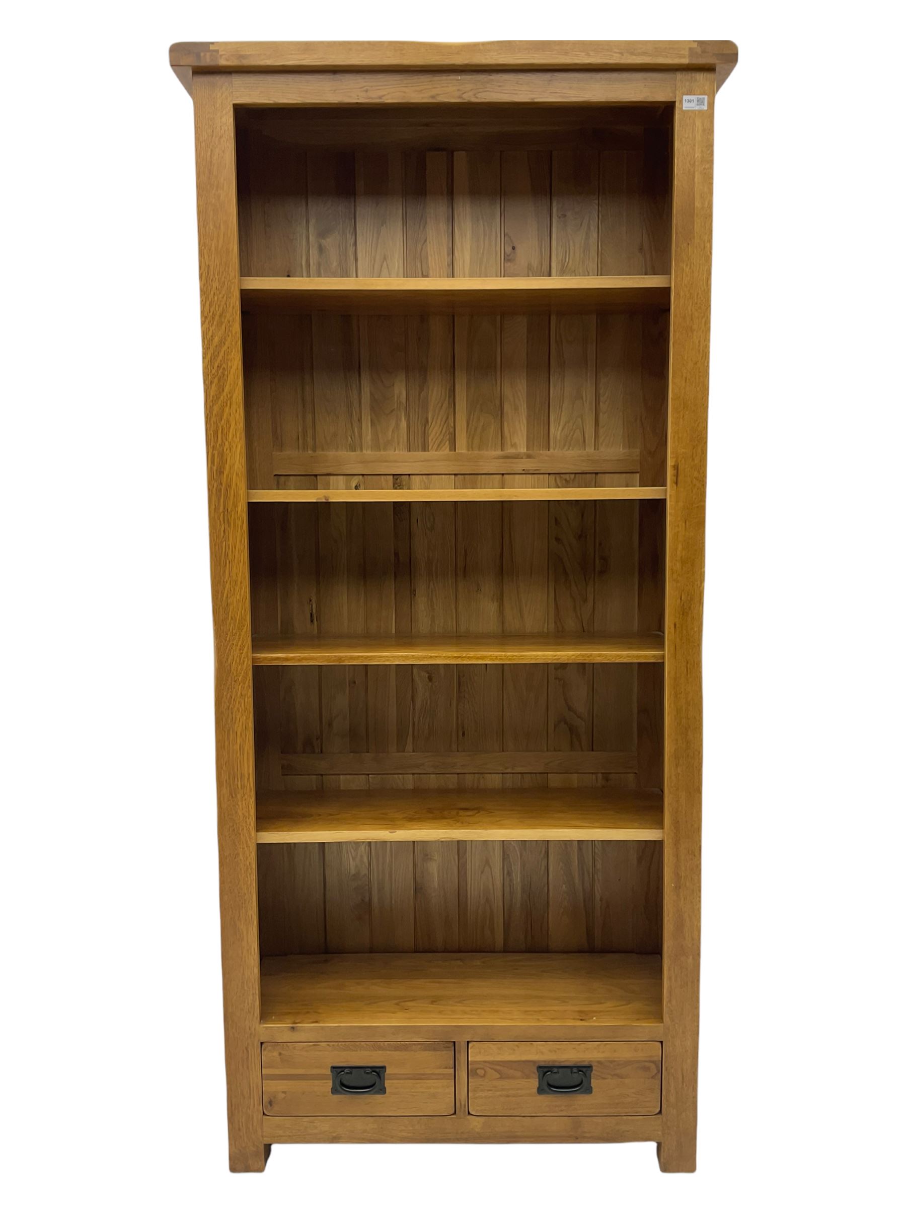 Light oak open bookcase, fitted with two drawers The Furnishings Sale