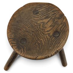 18th century ash and elm milking stool, circular figured top raised on cylindrical supports