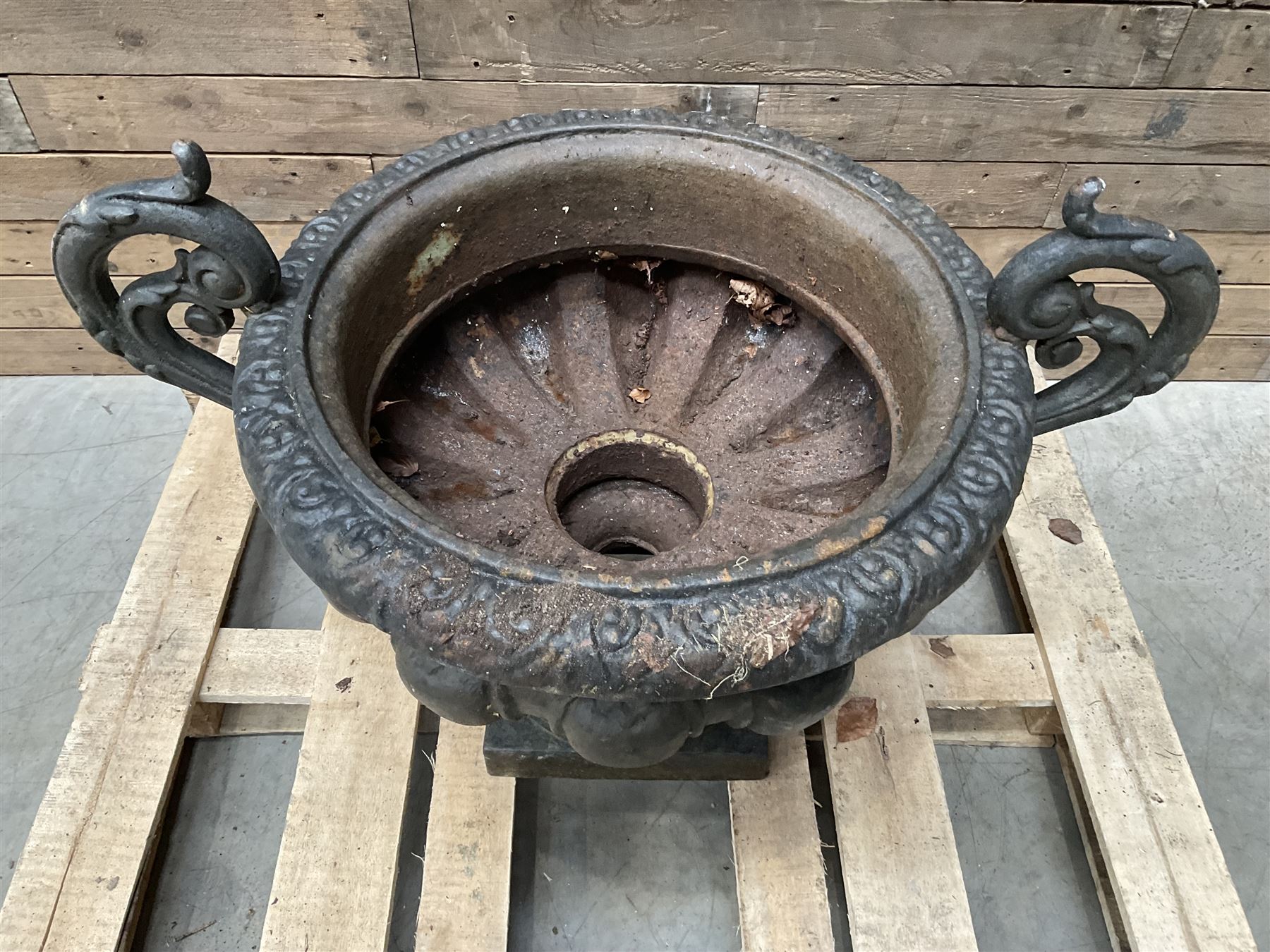 Victorian design ornate cast iron centrepiece urn, featuring two handles, raised on footed base