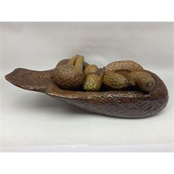 Helen Skelton (British 1933 – 2023): Carved wooden abstract sculpture, modelled as a fruit bowl with a adzed finish, with eight pieces of carved fruit, bowl W33cm, L52cm. Born into an RAF family in 1933 in Kent and travelled the world extensively during her childhood. After settling in Bridlington, Helen immersed herself in painting, textiles, and wood sculpture, often inspired by nature's beauty. Her talent was showcased in a one-woman show at Sewerby Hall and recognised with the sculpture prize at Ferens Art Gallery in 2000. Sadly, Helen’s daughter passed away from cancer in 2005. This loss inspired Helen to donate her sculptures to Marie Curie upon her passing in 2023.