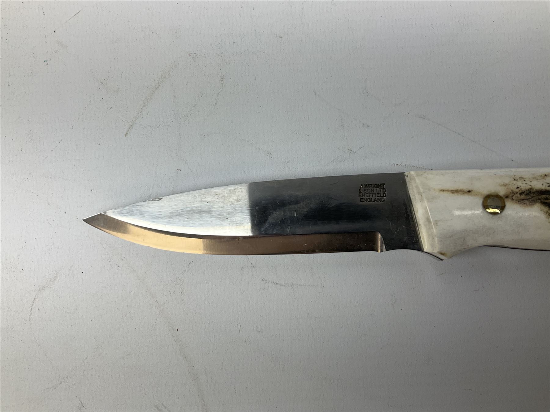 Three hunting knives, each blade marked A. Wright & Sons Sheffield, one with leather handle, one with horn handle and one with antler handle; each with leather sheath (3)