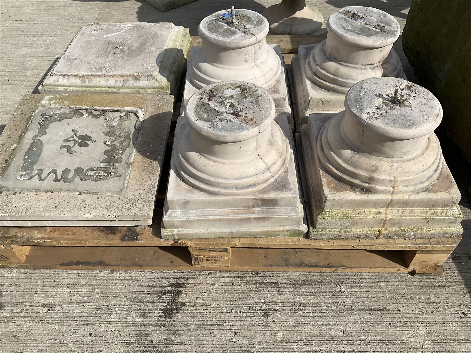 Set of four cast stone architectural columns, tapering form, on square plinth bases