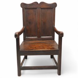 Early 18th century oak open armchair, high back with two recessed panels beneath scrolled cresting rail, curved arms and box seat, raised on square-section supports united by stretchers