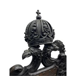 Grand mid-to-late 19th century heavily carved beech framed throne chair, the crown pediment carved with flower heads and cross finial, scroll and acanthus carved upright supports with twin perching griffin back enclosing etched leather work heraldic shield with castle and lion motifs over splayed feathers, flower head carved down sweeping arms with grotesque carved terminals, the seat rails carved with further flower heads on moulded supports with oversized ball and claw carved feet

Provenance: A very similar chair was used in the filming of Stanley Kubrick's 'Eyes Wide Shut' (1999)
