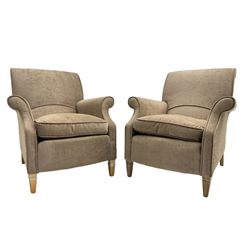 Pair of traditional shaped armchairs, scrolled back and arms, upholstered in beige fabric, raised on tapered beech supports