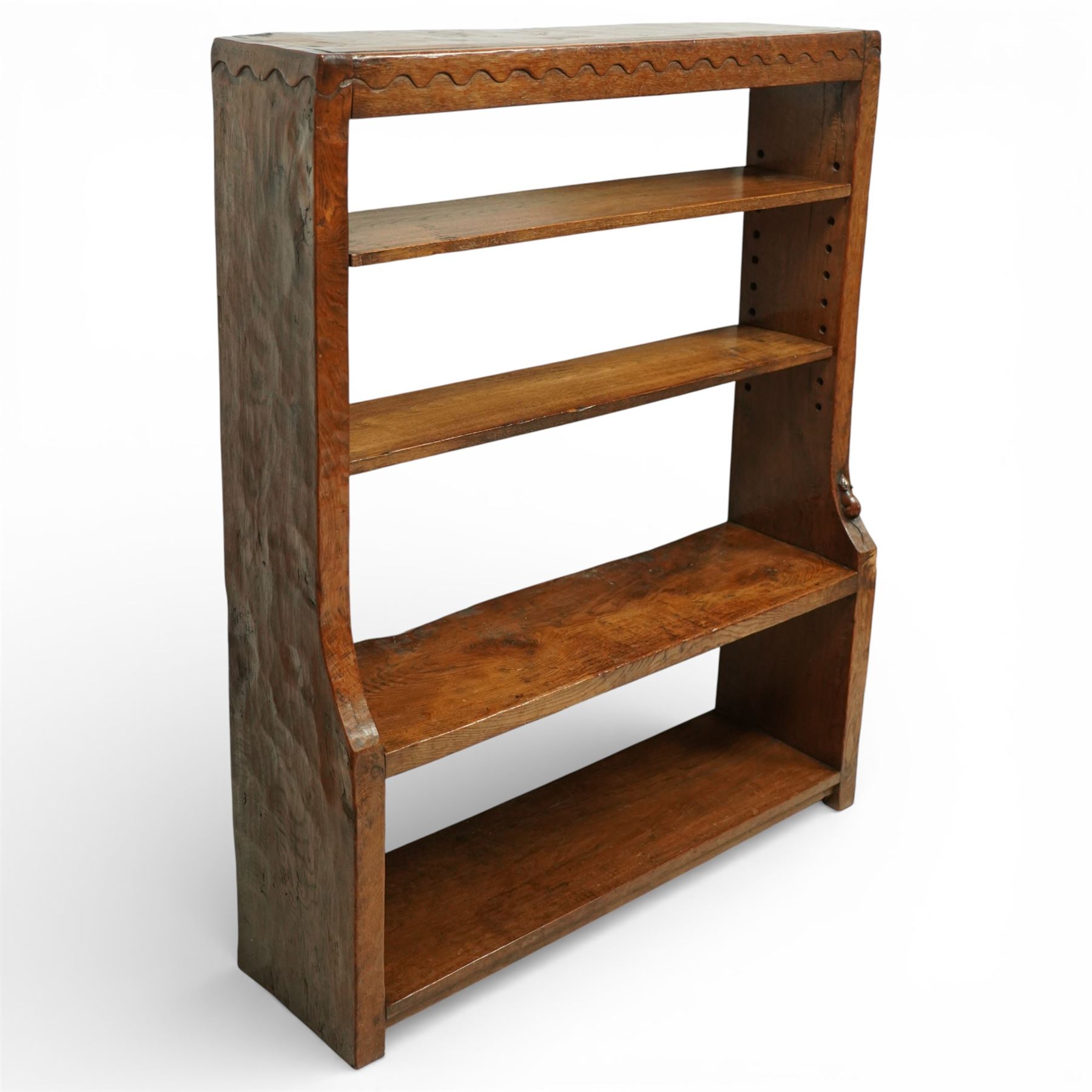 Mouseman - circa 1920s/1930s oak open back 3ft bookcase, the adzed top with scalloped detail, dual depth adzed ends, with two adjustable shelves over two fixed shelves, with carved fat mouse signature, by Robert Thompson of Kilburn