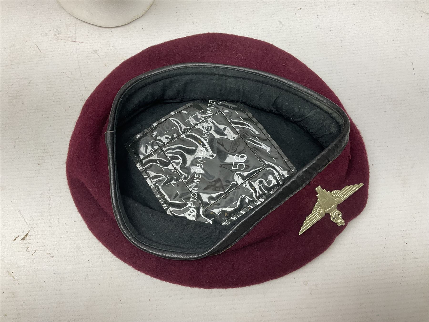 Five military caps/berets comprising two peaked caps with 'Yorkshire' and 'Royal Engineers' badges; maroon beret with parachute regiment badge; red beret with Military Police badge; and AB seaman hat with HM Submarines band; and a felt and webbing covered water bottle (6)