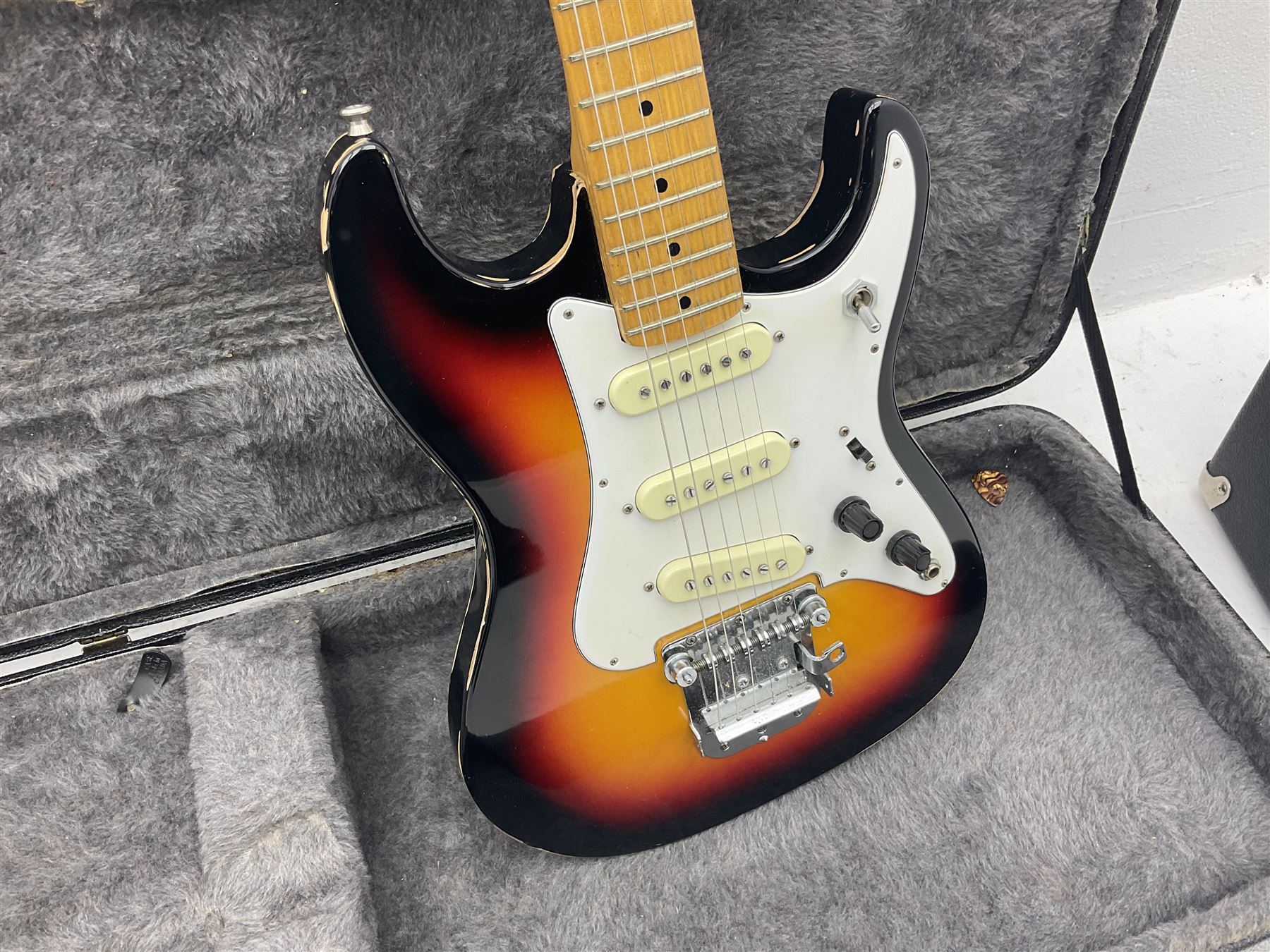 Fender style sunburst electric guitar with manuscript mark 'Zenta Stratocaster 1963' L97cm; in hard carrying case; another similar unmarked sunburst electric guitar; in gig bag; and Fender Frontman Amplifier, serial no.M473406 (3)