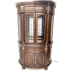 Kevin Charles American walnut demi lune display cabinet with illuminated interior, projecting cornice, two bevel edge glazed doors enclosing two adjustable shelves above single drawer and four cupboard doors with wine rack, carved scrolling supports 
