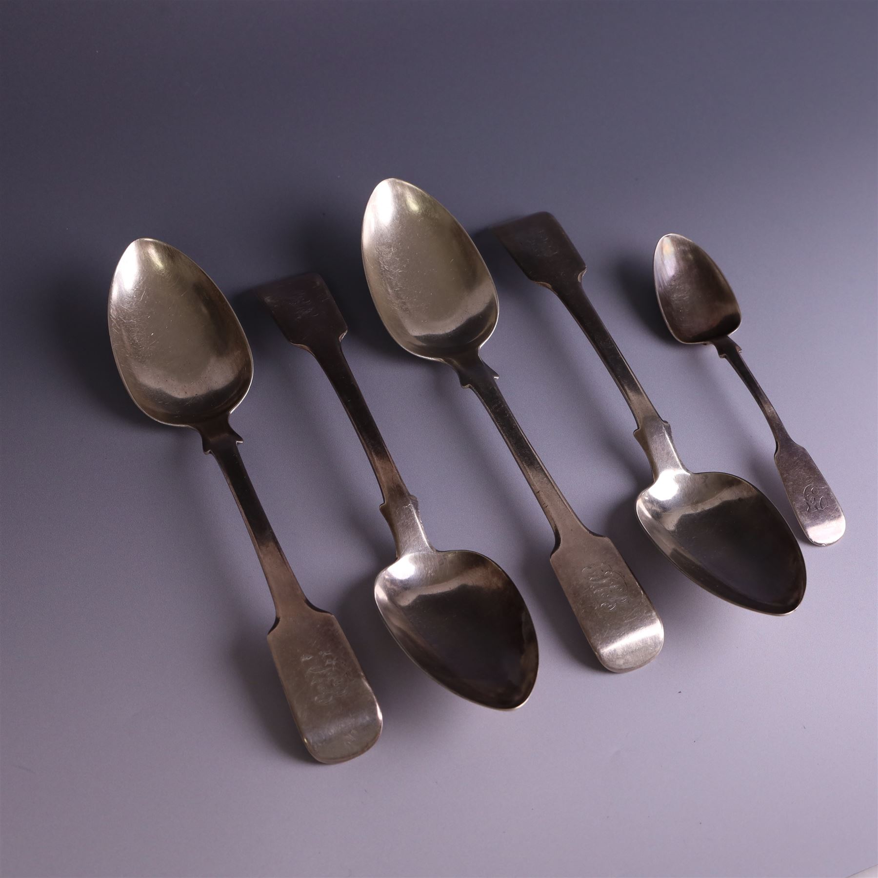 Set of four George III silver Fiddle pattern table spoons all engraved with monogram, hallmarked Thomas Wallis (II) & Jonathan Hayne, London 1819, together with a  Victorian silver Fiddle pattern teaspoon with engraved initials, hallmarked William Rawlings Sobey, Exeter 1846