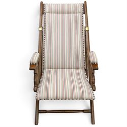 Pair of early 20th century oak framed garden reclining and folding deckchairs, high back and seat upholstered in striped fabric with padded armrests