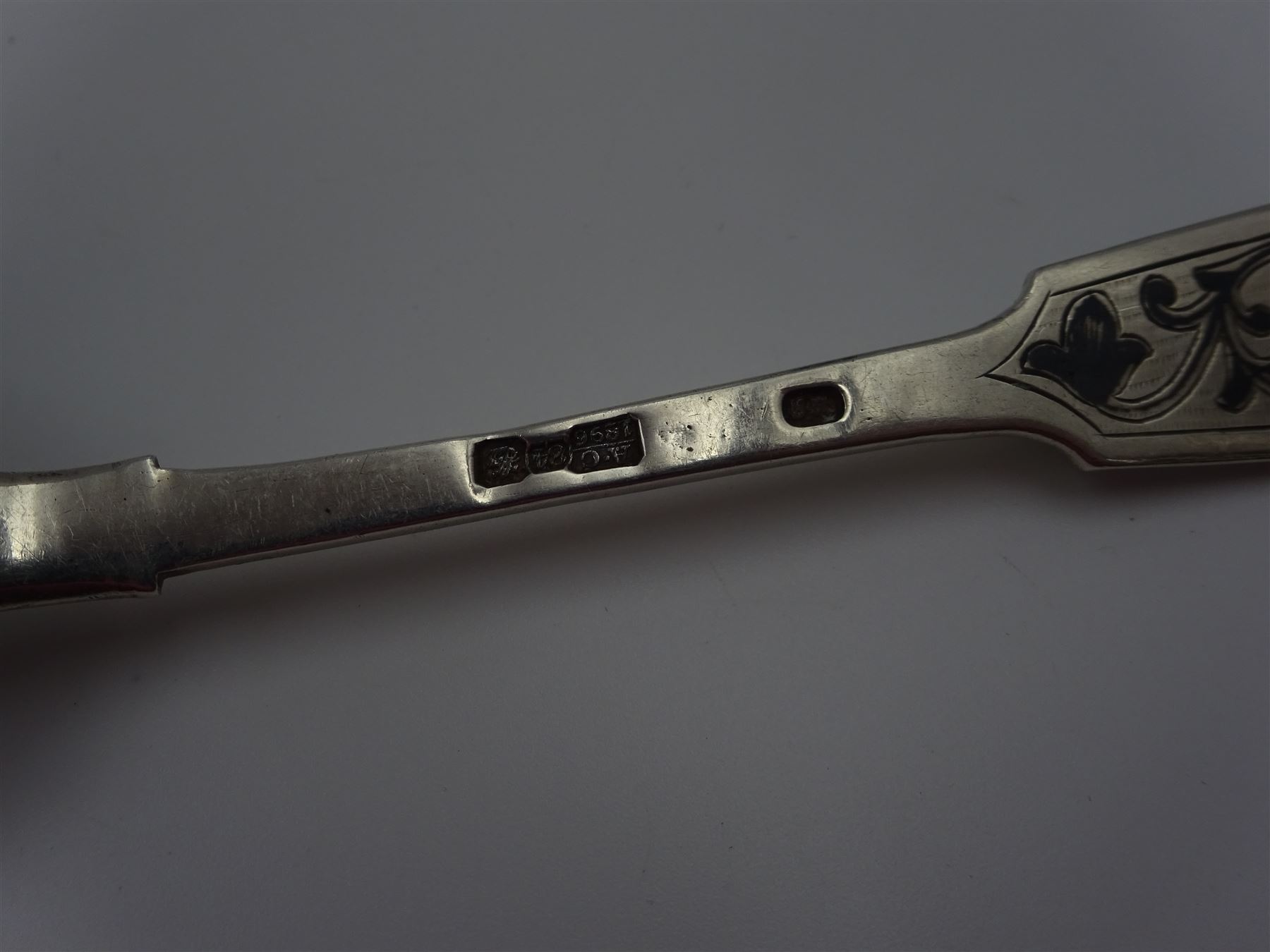 Late 19th century Russian silver Fiddle pattern niello work spoon, marked for 84 standard, Moscow, assayer Aleksander Vladislavovich Skovronsky, maker possibly Ivan Kuzmich Yashin, together with a Russian silver cake slice, marked with Kokoshnik mark, 84 standard, St Petersburg, maker Petr Chuksanov, and a pair of early 20th century silver sugar tongs, with shell bowls, hallmarked James Dixon & Sons Ltd, Sheffield 1913