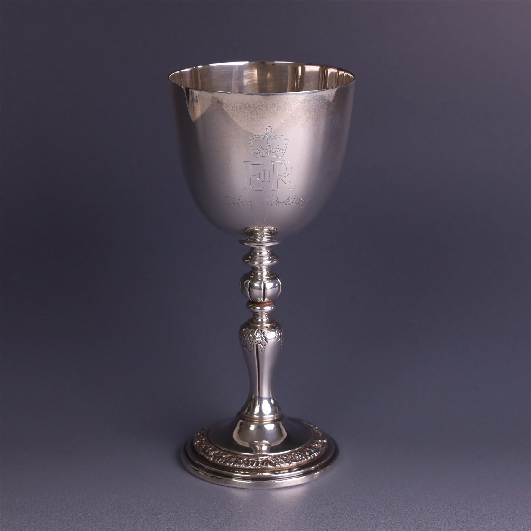 Late 20th century limited edition silver goblet, produced by Garrard & Co Ltd  to commemorate the silver wedding anniversary of Her Majesty Queen Elizabeth II and His Royal Highness the Duke of Edinburgh, the bowl engraved with Royal cyphers and anniversary dates, upon a knopped stem and embossed foot, no. 77/2000, hallmarked Garrard & Co Ltd, London 1972, H15cm