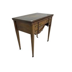 Edwardian inlaid mahogany games or work table, rectangular fold-over top inlaid with stylised dragon ivorine decoration and stringing, fitted with one long flanked by four small drawers over sewing compartment drawer, raised on square tapering supports with castors