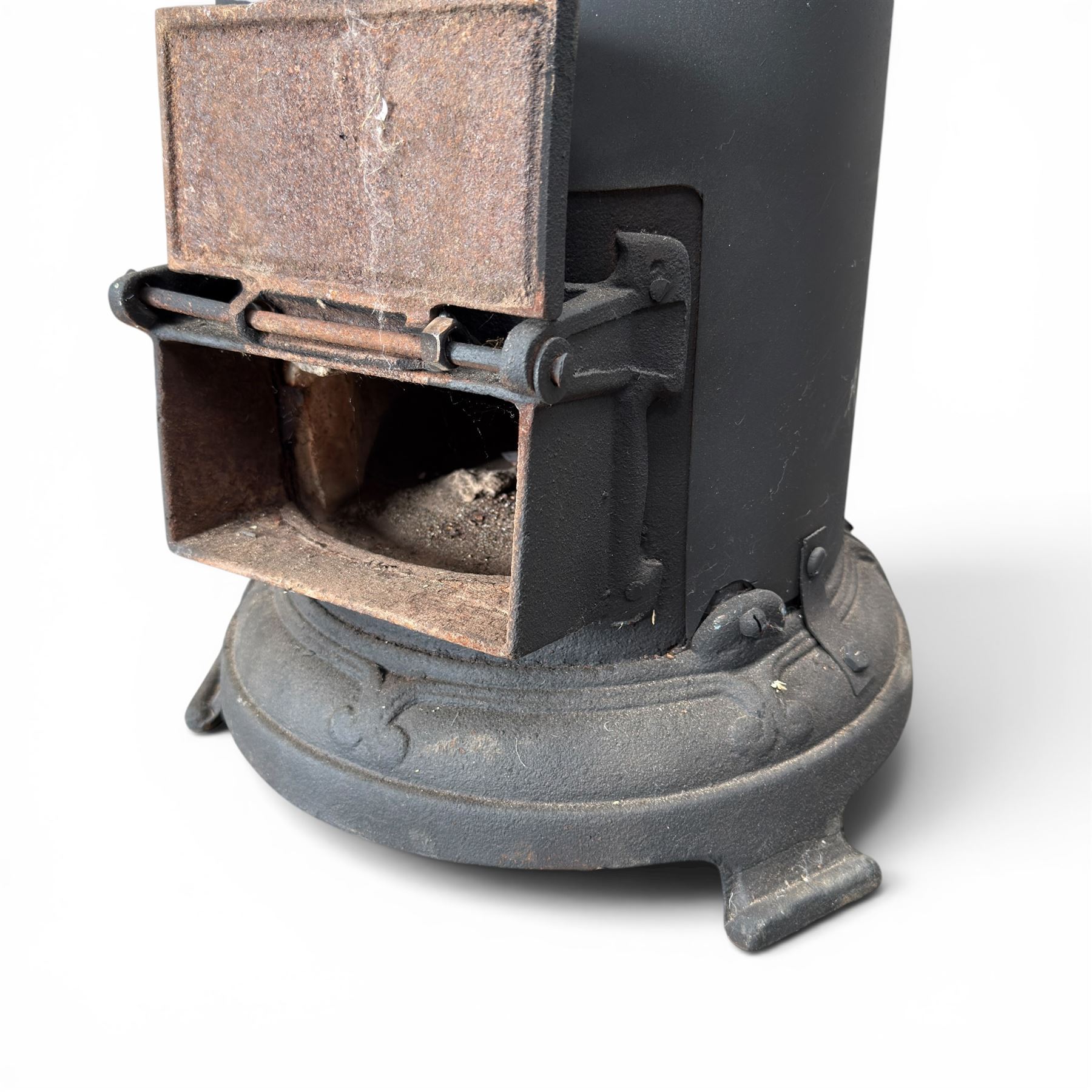 Late Victorian cast iron stove of small proportions, decorated with scrolls and central rosette to the top