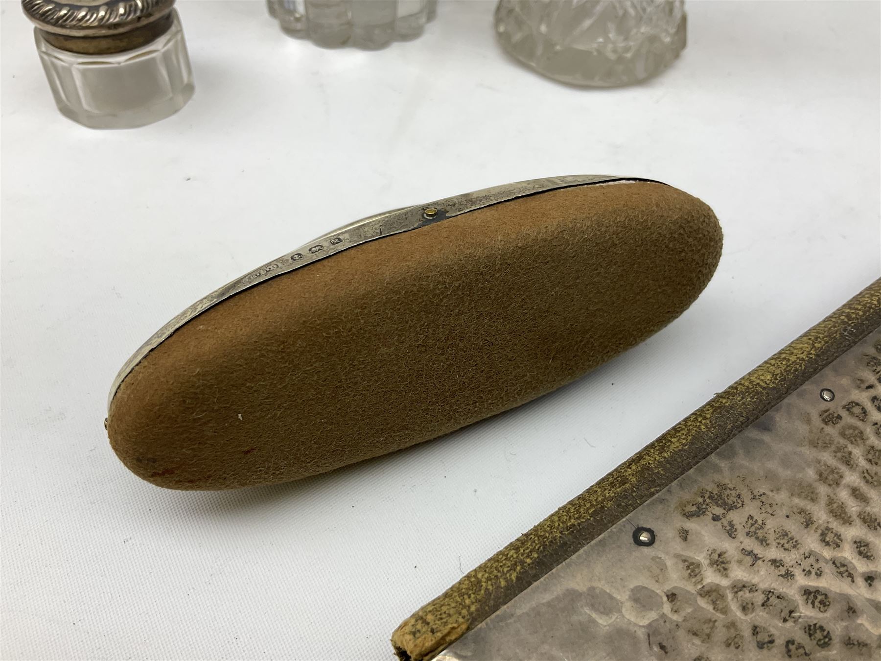Edwardian silver mounted purse, with circular panel engraved with initials, and hammered finish, hallmarked William Comyns & Sons, London 1903, H14cm, together with three dressing table glass jars with hallmarked silver covers, and a hallmarked silver mounted buffer 