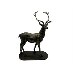 Pair bronzed cast iron life-size garden or indoor stags with raised heads, on oval plinth base