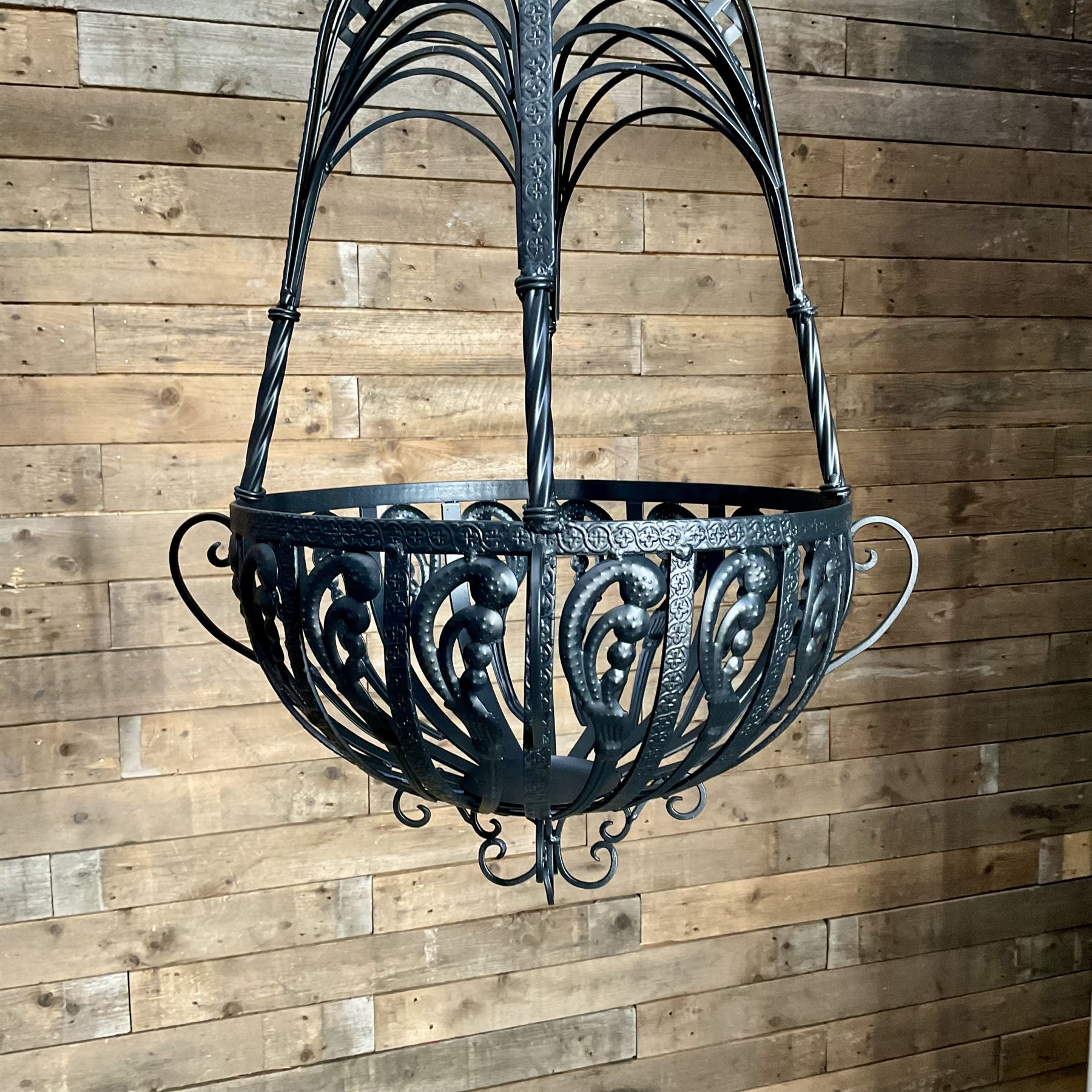 Pair of black finish wrought metal hanging baskets, with brackets