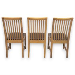 Contemporary oak extending dining table, moulded rectangular top with visible grain and inset extension leaf, pull out extending mechanism, standing on four square legs, accompanied by a set of high slat back chairs with upholstered brown faux leather seats and square tapering supports joined by stretchers