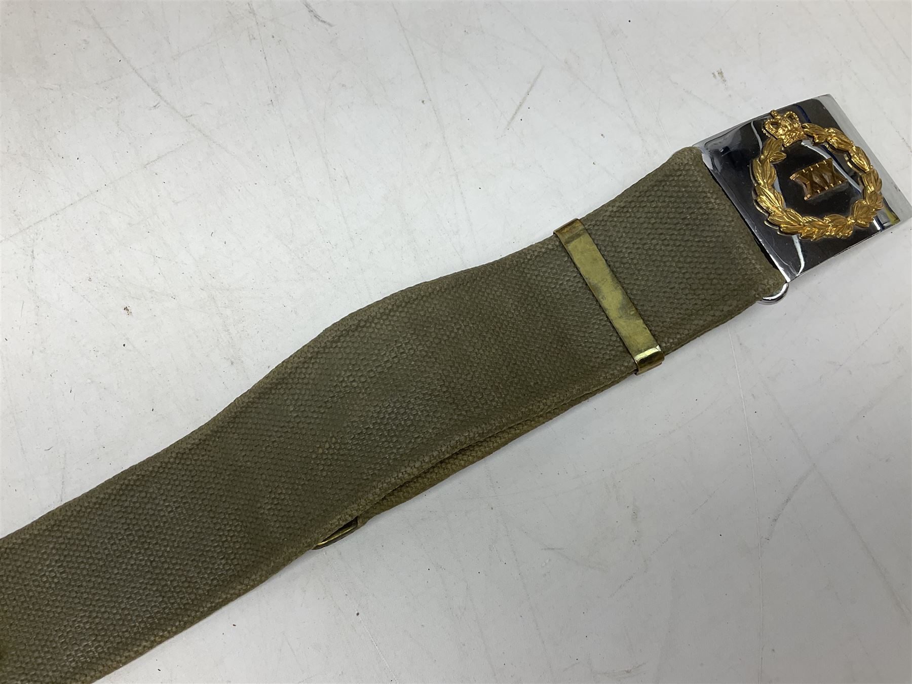 British Army Officers Sam Browne leather belt with shoulder strap; and webbing belt with Potter London Staybrite buckle for 19th Regiment of Foot (Green Howards) with various markings (2)