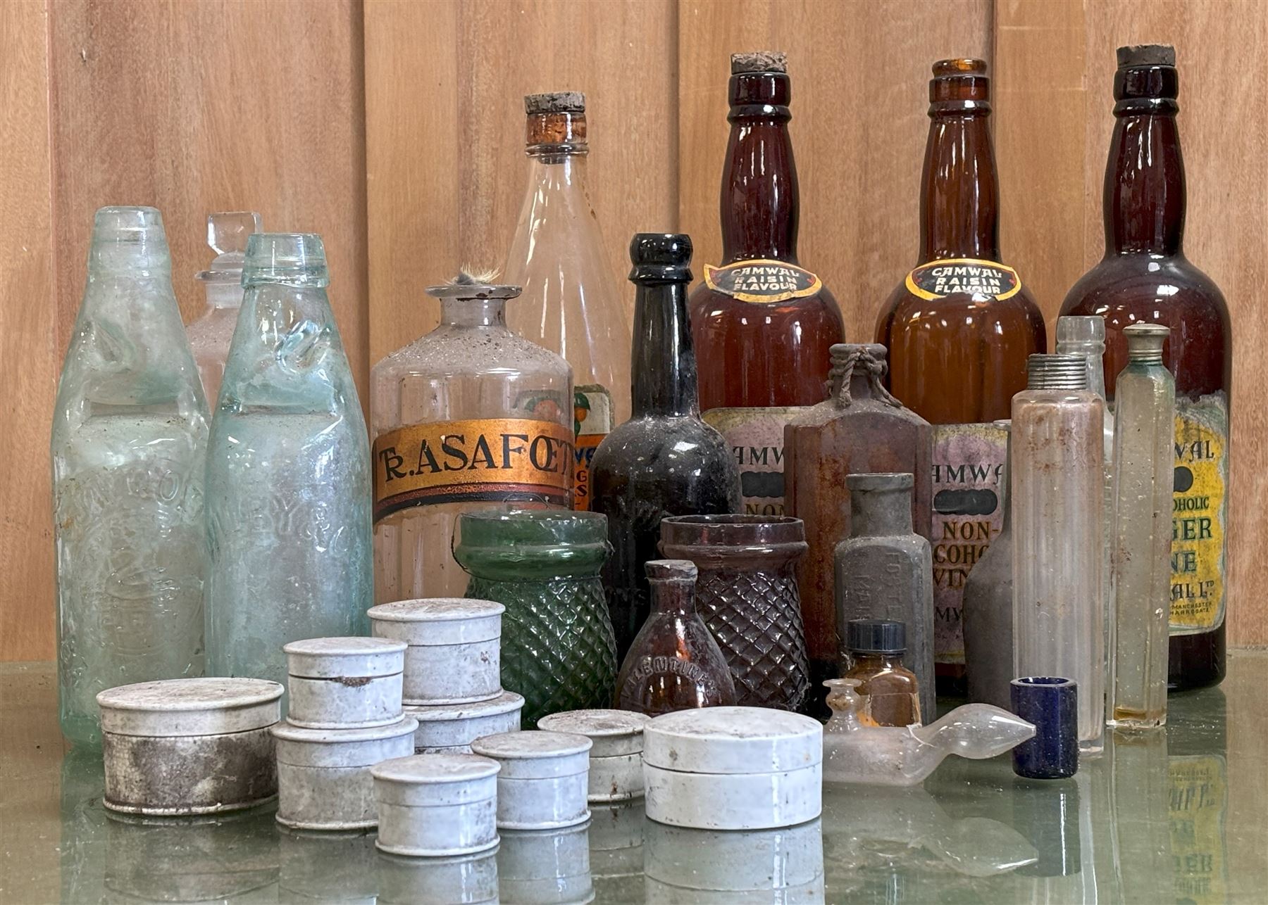 Collection of antique glass bottles and jars, including an apothecary bottle with gilt paper label, three Cranwell drinks bottles, two fish neck bottles, and a group of chemists preparation paste pots.  - COLLECTION BY APPOINTMENT FROM: The White House, Thirsk Road, Easingwold, York, YO61 3NF - CALL 01723 507111 TO ARRANGE