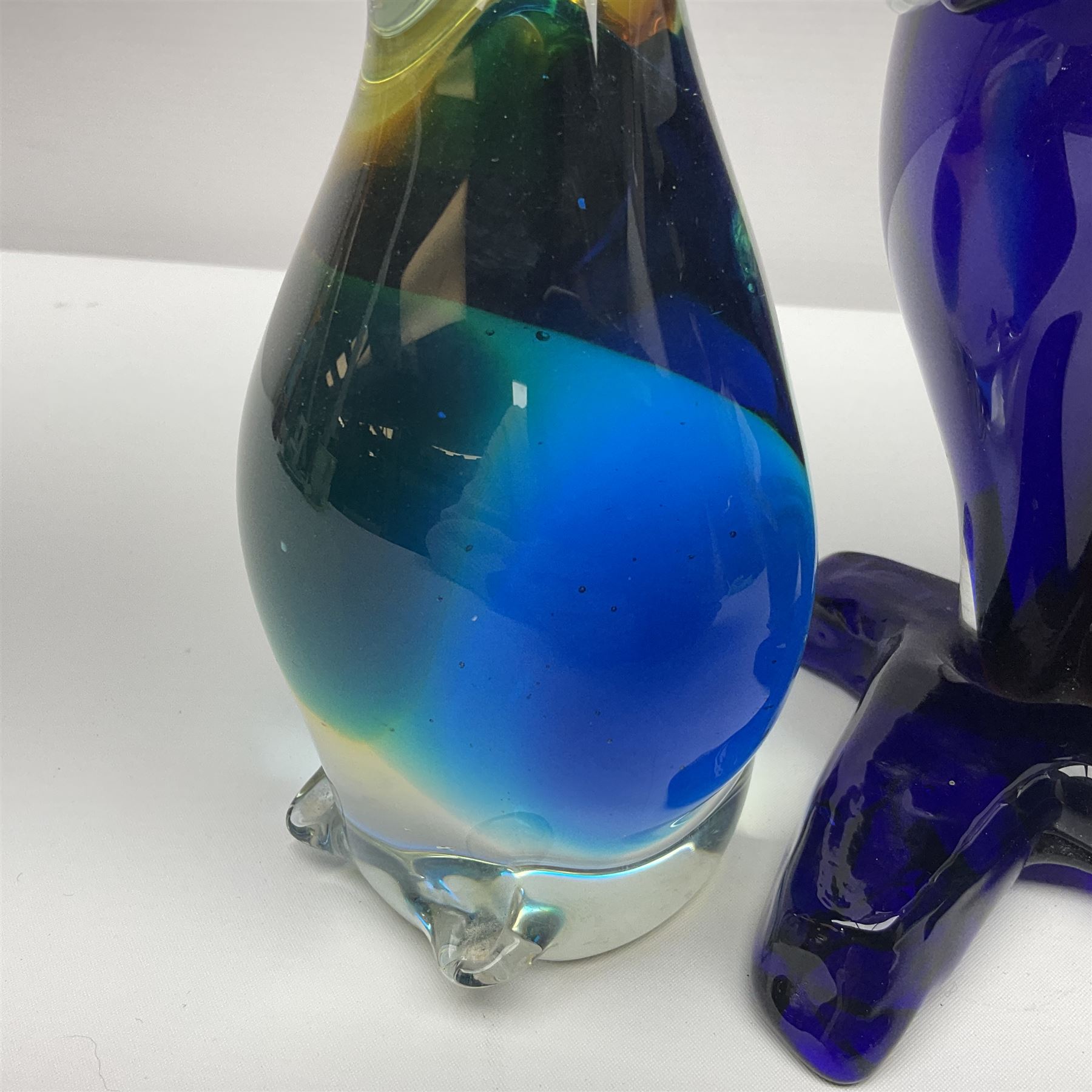 Murano glass clown, together with two glass penguin paperweights, clown H28cm