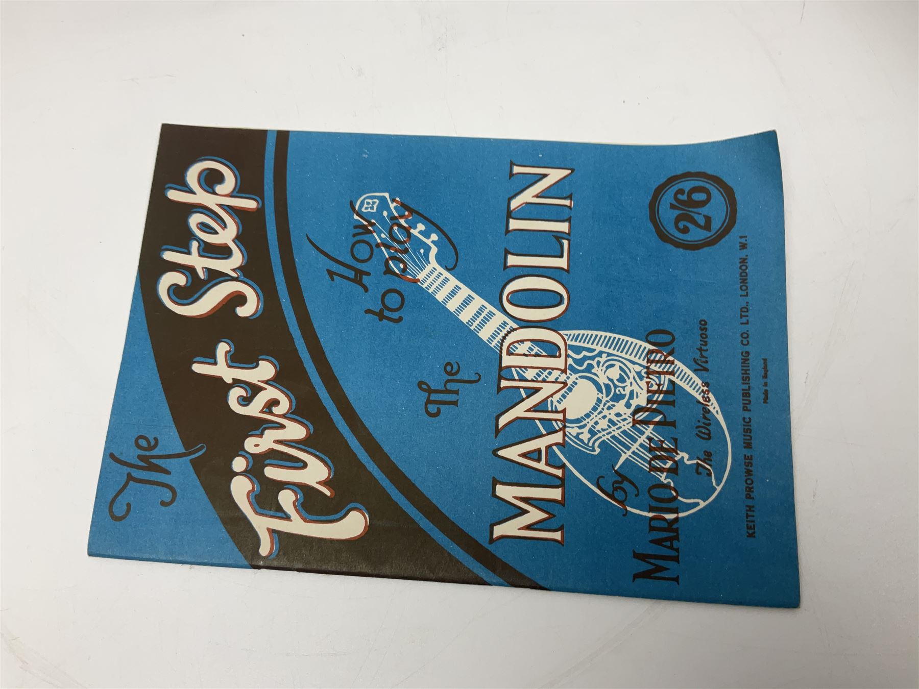 Late 19th/early 20th century Italian lute back mandolin with segmented back and spruce top; bears maker's label for Pietro Tonelli Napoli; together with a mandolin instruction booklet and a folding music stand L60.5cm